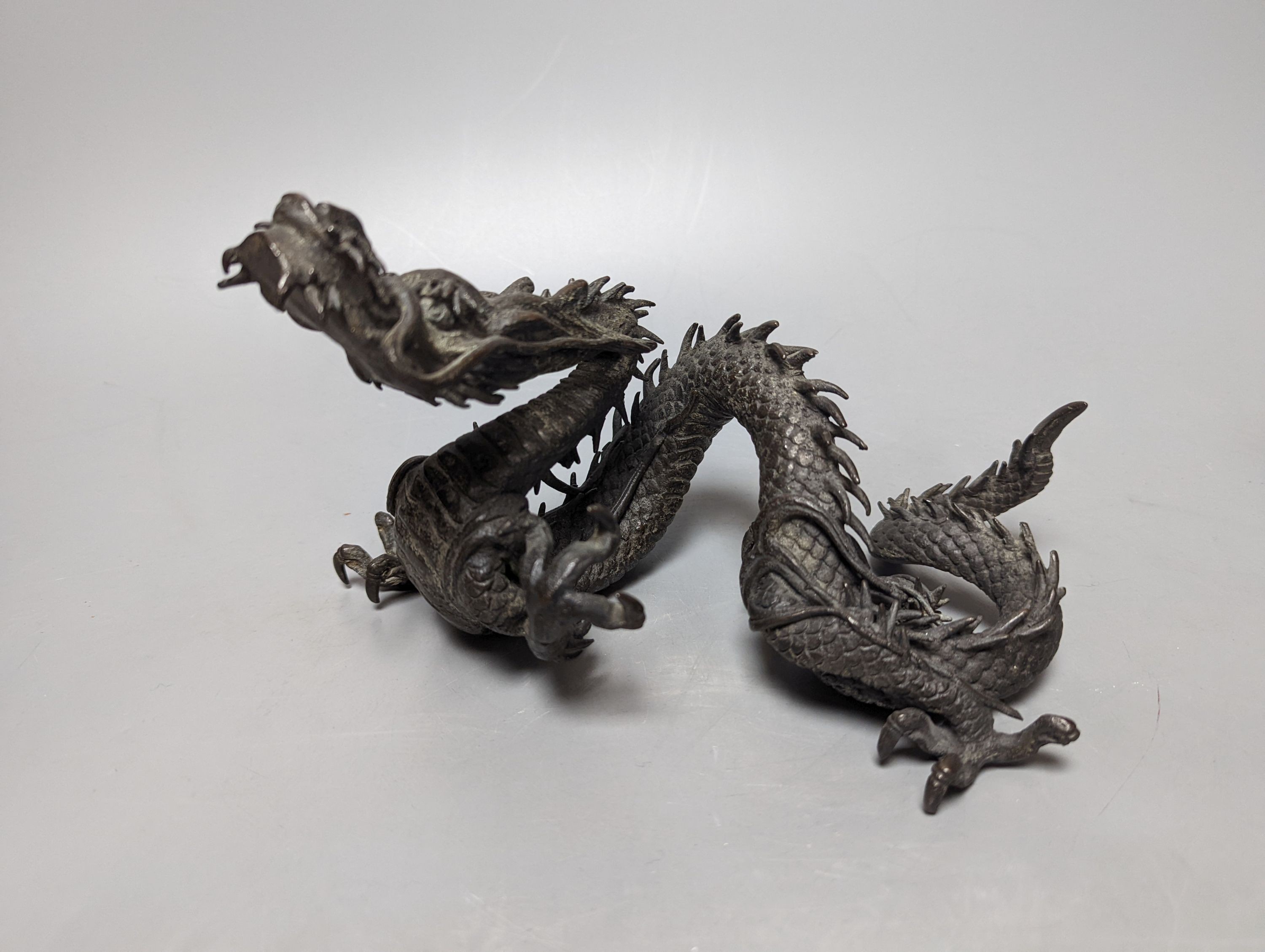 A pair of early 20th century Japanese bronze figures of dragons 22cm